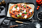 Homemade pizza on dark stone background, table top view_创意图片