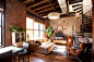 Loft living room with floor cloth, neutral palette, spiral staircase, sectional, exposed brick walls - By Chris A. Dorsey in Brooklyn, NY