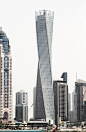 6月10日，总高310米、共73层的“卡延塔”在阿拉伯联合酋长国迪拜海滨区正式落成，这座摩天大厦外观新颖别致，最大特点是楼体实现了90度扭曲旋转，堪称全世界“最高最拧巴”的大厦。 卡延集团主席艾哈迈德·阿尔哈提在落成典礼上介绍说，大厦的设计灵感来源于人体DNA的双螺旋结构，楼体每一层之间都有1.2度的旋转错落，从而实现了总体90度转角的独特外观。图为6月11日拍摄的“卡延塔”。
20130613 #采集大赛#