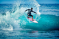 Young Man surfer Surfing in the Beach of Kauai, Hawaii