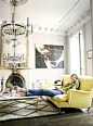 Love this comfortable, yet elegant room. Jenna Lyons living room. Bright canary yellow sofa, chandelier, art work.