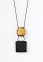 Square and Disk Pendant Necklace by Syra Gomez (Ceramic Necklace) | Artful Home : Square and Disk Pendant Necklace by Syra Gomez. The disk on this pendant moves up and down for a different effect. Made with matte black porcelain and accented with gold lus