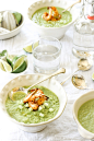 Bowls of green gazpacho soup with shrimp, limes, and cucumbers for a light dinner