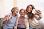 A teenage girl, mother and grandmother with smartphone at home. by Jozef Polc on 500px