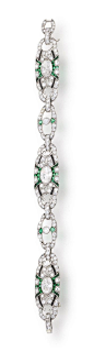 An art deco diamond, emerald and onyx bracelet, circa 1925  designed as three oval-shaped panels each centering an old marquise-shaped diamond within an openwork surround of round brilliant-cut diamonds, calibré-cut emeralds and (later) onyx, each with sm