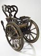 1850-1890轮椅，欧洲，木材及弹簧垫座椅、不像现代的轮椅有4个轮子，这把椅子有3个轮子，前面2个大的后面1个小的（小轮在哪？）。椅子也非常沉重，这意味着病人无法自己使用移动。