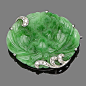 A jade and diamond brooch  The oval jade plaque carved with foliate motifs, highlighted with single-cut diamond scrolls, length 4.0cm