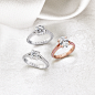 Three Graff Legacy engagement rings on a table with white fabric