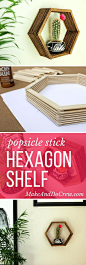 Add some mid-century charm to your gallery wall with this DIY wall art idea. All you need is popsicle sticks, glue and some stain to make this inexpensive home decor knockout. Click to see the full tutorial and download the hexagon template. | MakeAndDoCr