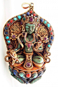 Tibet | Pendant representing Bhodisatva Guanyin or Avalokiteshvara, God of compassion | ca. mid 20th century | Fire gilded silver, turquoise, coral, lapis lazuli and ruby | Price on request