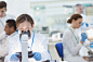 Scientist examining sample under microscope in laboratory by Caia Images on 500px