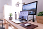 A MacBook and an iMac on a neat desk in a bright room