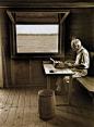 E.B. White writing in his boat shed overlooking Allen Cove, 1976.