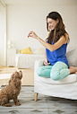 Caucasian woman training pet dog in living room by Gable Denims on 500px