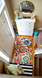 bright colored small entry foyer in a split entry with shoe storage | 100+ Beautiful Mudrooms and Entryways at Remodelaholic.com