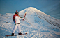 An Olympic torch bearer holds the torch near Avachinsky Volcano, on the Kamchatka Peninsula, on November 12, 2013.(AP Photo/Olympictorch2014.com)