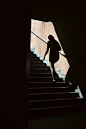 a woman walking up a flight of stairs