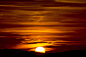 Free photo beautiful closeup shot of a sunset with read sky and half sun in tuscany, italy