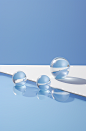 a reflective surface with some water on it, in the style of sculptural objects, playful minimalism, light azure and white, delicate still-lifes, luminous spheres, delicately rendered landscapes, memphis design