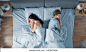 Quarrelling Young Couple in the Bed, Young People Lying Turned Away From Each other and Lay on Their Sides Holding Grudges and Being Offended 库存照片
