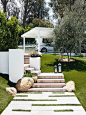 Welcoming you to this home is a landscaped front yard that has a stone path leading you to the front door, broken up by patches of grass, creating a unique look and adding interest to the yard.:
