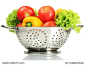 fresh vegetables in silver colander isolated on white