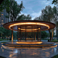 This may contain: an illuminated circular structure in the middle of a park