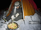 Mature woman cooking outside tent at night, Langjokull glacier, South Iceland_创意图片