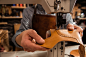Man cobbler stitching leather parts