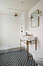 Tiled bathroom floor with marble and brass sink: 