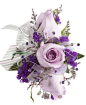 DECORATED ROSE CORSAGE, LAVENDER - A corsage with three lavender roses, purple statice, caspia, and is decorated with three purple rhinestones and a white & silver bow. Designed as a wrist corsage, but can be converted to a pin on corsage with include