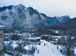 Snow Covered House Near Snow Covered Mountain Under Clear Sky