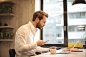 Man Holding Mug in Front of Laptop · Free Stock Photo