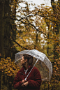 woman holding umbrella under tree