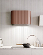 This may contain: a white counter top with pots and pans on it next to a wall mounted light