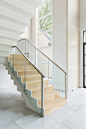 Inspiration for a contemporary wooden u-shaped glass railing staircase remodel in Dallas with wooden risers