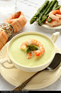 Delicious cream soup with asparagus and shrimp. Selective focus - stock photo