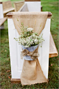 burlap, galvanized pail and white flower rustic aisle decor and white church pews for outdoor wedding | photo: www.jhendersonstudios.com