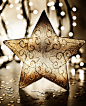 3141418-953127-star-christmas-tree-ornament-golden-decoration-over-blur-lights-dark-new-year-eve-background-winter-holidays-home-decor