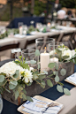 eucalyptus and candle centerpiece, photo by Katrina Louise http://ruffledblog.com/secluded-garden-estate-wedding #centerpieces #wedding #reception: 