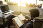 Young man reading a book in a cafe.