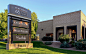 A multi-tenant monument sign is constructed of aluminum with a masonry base.