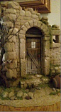 This may contain: there is a fake stone building with a door and window in the middle of it