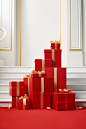 In this illustration, red boxes with ribbon on top of them, in the style of large-scale photography, elegant compositions, carpetpunk, xmaspunk, minimalist still lifes, light white and gold, lively interiors