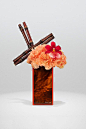 Orange Dianthus, sugar cane and red Cambria orchid on turtle plexiglass vase Armani Flowers: