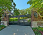 English Tudor Estate & Gardens : A luxurious English Tudor residence and estate property in Dallas, Texas. The property features expansive lawns and gardens, decorative entry gates and fence, a formal luxury pool, koi pond, formal
