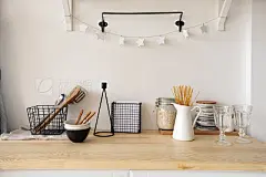 Furniture and dishware in kitchenVarious lovely accessories standing on shelf and cupboard in cozy kitchen