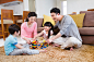 年轻双亲,进行中,积木,家庭生活,亲情_e4f6b9fc1_一家人坐在地毯上搭积木_创意图片_Getty Images China