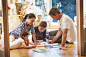 Family drawing and coloring on floor in living room by Caia Images on 500px
