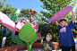 Noah Workman, 3, and Jacob Brown, 10, assemble giant flower petals at an exhibit designed to teach parts of the plant at the new 8-acre Rory Meyers Children's Adventure Garden in Dallas.